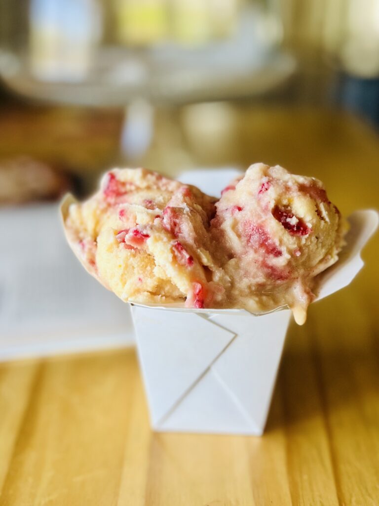 Citrus strawberry ice cream in a takeout container
